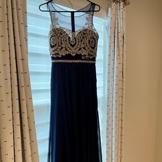 Never Worn Navy Illusion Neck Dress Size Medium With A Line Design, Gold Beads On Top. See Pictures For Details Elegant Beaded Homecoming Dress, Blue Beaded Evening Dress For Prom, Elegant Homecoming Evening Dress With Crystals, Glamorous Blue Evening Dress With Sheer Bodice, Blue Embellished Evening Dress For Homecoming, Royal Blue Embellished Dress For Homecoming, Embellished Royal Blue Dress For Homecoming, Glamorous Blue Dress With Sheer Bodice, Blue Beaded Prom Dress