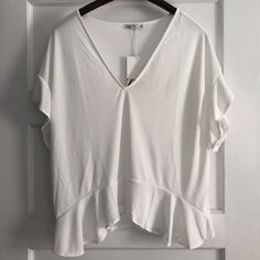 New With Tags! Please See Photos For Small Imperfection. Oversized Fit. Great Basic Top. Interested? Make An Offer! White V-neck Top With Ruffles, White V-neck Ruffle Top, White V-neck Ruffled Tops, Chic Relaxed Fit Zara Tops, Zara Feminine Short Sleeve Tops, Zara Short Sleeve Blouse With Ruffles, Zara V-neck Blouse With Relaxed Fit, Zara Ruffled Tops For Brunch, Zara Short Sleeve Tops For Brunch