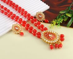 This is a stunning handmade necklace perfect for high end Jewelry Collector, a keeper in Traditional Vintage Indian/Pakistani Bridal jewelry and a Luxury Gift for your Daughter, Sister or Wife on Wedding or Anniversary. Perfect for any type of occasions, weddings And celebrations and a beautiful & memorable gift for weddings and special occasions. -Item Code:- L9407 -Red Beaded & Kundan Necklace Set with Earrings. -Designer multi layered necklace. -Gold Plated Set with Kundan Stones which shine like Polki Diamonds. -Metal: Gold plated brass -Earrings are 45mm long & 25mm wide approx -Push Back Earrings -Necklace length with pendant 10" approx excluding adjustable dori/cord -Quantity - One Necklace Set Please see more different designs here:- https://www.etsy.com/in-en/shop/LUCKYJEWELSART?r Traditional Luxury Kundan Choker Necklace, Luxury Red Beads For Gifts, Multi Layered Necklace, Pakistani Bridal Jewelry, Necklace Set With Earrings, Kundan Necklace Set, Bridal Pearl Necklace, High End Jewelry, Multi Layer Necklace