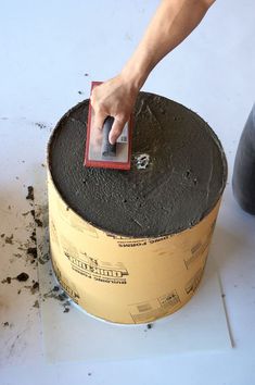 a person using a sponge to clean a cake