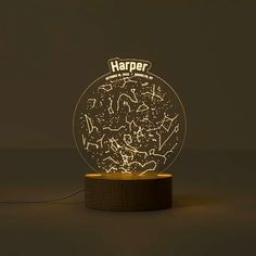 a light that is sitting on top of a wooden stand with the word harper written in it