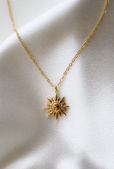 Showcase your inner sunshine with our stunning Sonne Necklace. Crafted with 18k gold plated stainless steel, this Rapunzel inspired necklace radiates beauty and joy - perfect for adding a little sparkle to any outfit. Shine bright! Sunshine Necklace Gold, Gold Sun-shaped Necklace As A Gift, Gold Sun-shaped Necklace For Gift, Gold Sun-shaped Necklace Gift, Gold Sunburst Jewelry For Gift, Gold Plated Sun Design Necklace As Gift, Gold Plated Sun Design Necklace Gift, Handmade Sun-shaped Necklace For Gifts, Dainty Gold Sun-shaped Necklace