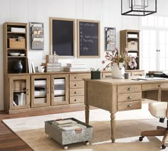 a home office with wooden furniture and white walls