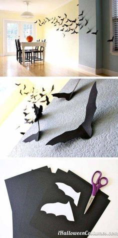 some paper bats are on the floor and one is cut out to look like batmans