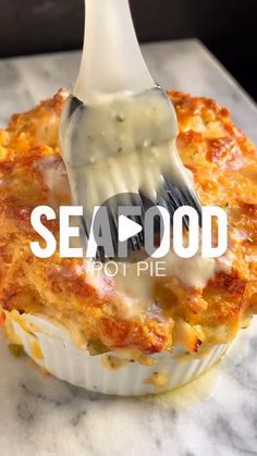 a fork is stuck into some food in a muffin dish with the words seafood to pie written on it