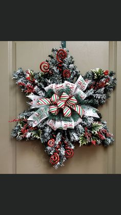 a christmas wreath with candy canes and candies hanging on the front door ornament