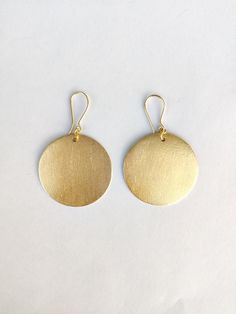 Here's the Mini version of our best-selling piece - Handmade Small African Disc Gold Earrings. The earrings are handmade and the round-shaped bold earrings are the most trending product of the season.  The earrings are the best choice for a chic look. Specifications: Brass Earrings Handmade Jewelry Gold Plated Round - Disc Shape Ear wire closure Bold Statement Jewelry Hypoallergenic Nickel & Lead-free Yellow Gold Circle Brass Earrings, Yellow Gold Circle Earrings In Brass, Minimalist Circle Brass Earrings, Handmade Brass Round Danglers, Gold Minimalist Round Pendant Earrings, Circular Brass Earrings With Ear Wire, Brass Circle Earrings With Ear Wire, Everyday Brass Circle Earrings, Everyday Brass Circular Earrings