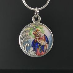 A magnificent antique silver enamel Pieta medal, petite Austrian enamel amulet on a 16 inch long sterling chain, rare Virgin Mary Catholic charm, very nicely done, in good condition, ideal for strength and protection necklace, would make a nice gift for someone special! Comes with approx. 16 inch long 925 silver necklace (see photo 5)! Material: solid silver, enamel Measures: approx. 22 mm (0.8 inch) in diameter A stunning religious jewelry shop well worth a visit ... https://www.etsy.com/shop/1 Oval Engraved Enamel Necklace, Collectible Jewelry With Miraculous Medal Round Pendant, Collectible Miraculous Medal Round Pendant, Collectible Round Miraculous Medal Jewelry, Enamel Medallion Necklace With Hallmark, Engraved Oval Pendant Enamel Necklace, Engraved Oval Pendant Necklace In Enamel, Engraved Enamel Oval Pendant Necklace, Silver Enamel Round Pendant Necklace