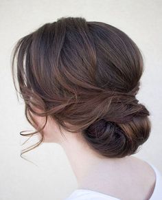 a woman with her hair in a low bun