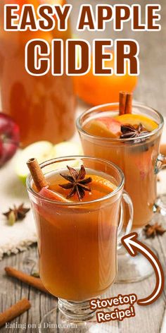 two glasses filled with apple cider and cinnamon sticks