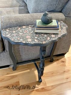 a table with a book on top of it next to a couch