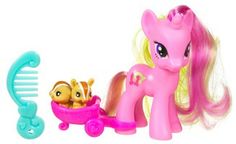 a pink pony pulling a toy carriage with two little dolls in it's back