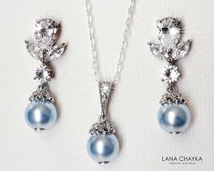 Wedding Light Blue Blush Baby Blue Colored Pearl Cubic Zirconia Silver Dainty Bridal Earrings and Necklace Jewelry Set with .925 Sterling Silver Chain. EARRINGS are 1.06 inch (2.7cm) long from top of erring stud to bottom. CHAIN is 18 inches (45.7cm) long. PENDANT is about 0.82 inch (2.1cm) including bail. Elegant and timeless, these dainty jewelry set is perfect for weddings or special occasions such as birthdays, anniversaries, graduations, proms...or whatever you can imagine! Handmade jewelry Blue Dangle Necklaces For Wedding, Elegant Light Blue Necklace For Wedding, Elegant Light Blue Wedding Necklaces, Blue Round Jewelry Sets For Wedding, Blue Pearl Drop Jewelry For Wedding, Blue Pearl Drop Wedding Jewelry, Blue Pearl Drop Necklaces For Wedding, Blue Pearl Drop Necklace For Wedding, Blue Pearl Drop Bridal Earrings For Wedding