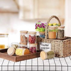 a basket filled with lots of different types of spices on top of a white table