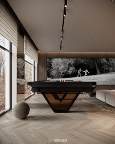 a pool table in the middle of a room with a large screen on the wall