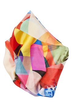 the multicolored scarf is folded on top of another piece of cloth, which looks like an abstract painting