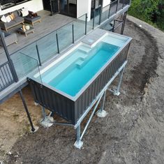 an aerial view of a house with a swimming pool in the yard and deck area