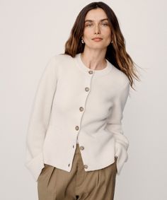 Cooper Cardigan Warm Ivory Featuring a structured silhouette that nips in at the waist and a very slight bell sleeve that instantly elevates any ensemble, this iconic cardigan effortlessly holds its own in any wardrobe. The fitted body enables versatile styling: wear it open like a blazer with a t-shirt underneath or buttoned up as a pullover. | 70% wool, 30% cashmere. Made in China of Peruvian yarn. Fitted button-down cardigan. Dry clean. Fits true to size. | Jenni Kayne Women's Cooper Cardigan Elegant Fitted Sweater Coat For Daywear, White Cashmere Cardigan With Button Closure, Classic Cream Cardigan For Work, Classic Winter White Cardigan For Work, Fitted Classic Beige Sweater Coat, Fitted Beige Classic Sweater Coat, Cream Cashmere Outerwear With Button Closure, Classic White Wool Cardigan, White Classic Cardigan With Button Cuffs