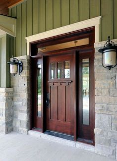 a wooden door with two lights on each side