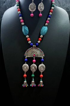 Dramatic, colorful oxidized silver Indian peacock necklace, with bead jhumka. The large central medallion is in the shape of an open peacock tail with a sparkly crystal border. Variety of bead shapes and sizes add visual interest. Perfect for tropical beach vacation as it is fun, lightweight and goes with all colors in your wardrobe. This is a very attractive necklace! You are certain to get many compliments! Necklace is 9.5 cm. Lobster claw clasp. Pendant measures 5 in x 3 in. including the dan Silver Peacock Design Jewelry Sets For Festivals, Multicolor Peacock Design Temple Jewelry Sets, Multicolor Peacock Temple Jewelry, Multicolor Peacock Design Temple Jewelry, Bohemian Sterling Silver Jewelry With Latkans, Silver Peacock Necklace For Festivals, Silver Peacock Design Necklace For Festivals, Silver Necklace With Peacock Design For Festivals, Multicolor Peacock Design Jewelry Gift