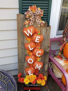 a welcome sign made out of pumpkins and flowers