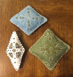 three small pieces of cloth sitting on top of a wooden table