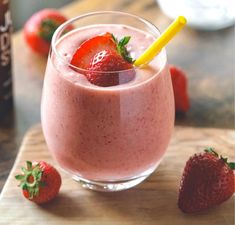 a smoothie with strawberries on the table