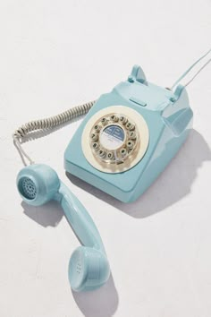 an old - fashioned rotary phone is laying on the floor