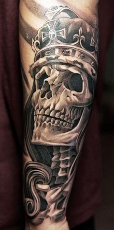 a man with a skull and crown tattoo on his arm