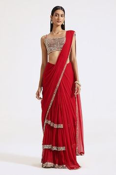 Red pre-draped saree with contrast cutdana beaded border. Paired with a padded silk blouse with all over mirror and zari embroidery. - Aza Fashions Red Draped Georgette Saree, Red Pre-draped Saree With Cutdana, Red Draped Designer Choli, Fitted Red Pre-draped Saree With Cutdana, Red Cutdana Pre-draped Fitted Saree, Red Fitted Pre-draped Saree With Cutdana, Red Draped Saree With Unstitched Blouse, Red Draped Georgette Choli, Red Pre-draped Saree For Reception