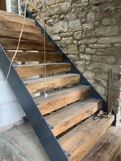 the stairs are made out of wood and have metal handrails attached to them