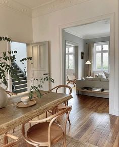 a dining room with wooden floors and white walls