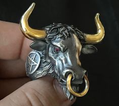 🔱 Embrace the strength, power, and spiritual guidance of the Hell Bull ring. Rise up to any challenge with this extraordinary piece of jewelry loaded with unapologetic Mortis Ores DNA and created with meticulous craftmanship. Designed to honor the fight through any obstacles, this Hell Bull ring will give you the bullish spirit to rise and win it head on. Make it a symbol of your strength and wear it as a statement! 🔱 The ring weighs at approximately 75 grams of 925 sterling silver with 22K go Hand Forged Symbolic Rings For Collectors, Symbolic Hand Forged Rings For Collectors, Black Horns, Bull Ring, Exotic Jewelry, Animal Bones, Bull Skulls, Bespoke Jewellery, Bling Rings