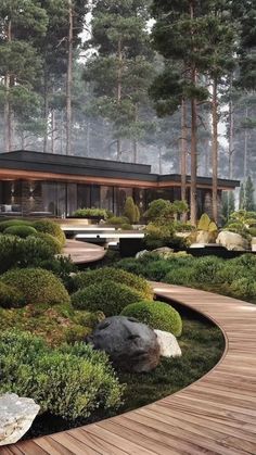 a house in the woods surrounded by trees and rocks with a wooden walkway leading to it