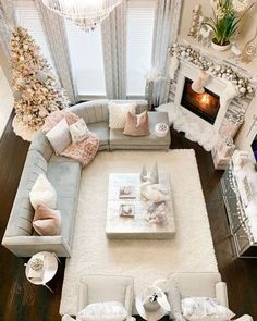 an aerial view of a living room with couches, coffee table and christmas tree