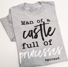 a man of castle full of princesses t - shirt sitting on top of a table