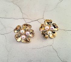 "Presenting a beautiful pair of CLIP ON earrings with mixed colour faux pearls and diamante in a gold tone cluster flower style, absolutely stunning addition to your outfit and with a beautiful sheen. Measuring approximately 3.2 cms in length and 3.2 cms in width. Please note the model is not full size.  Available in a stud version simply choose your preferred earring back from the drop down menu above. I do offer combined shipping on all my items, although this may mean a slight delay on delivery as some items are already made up and others will need to be created especially for you.  If you'd like to take advantage of the combined shipping option please pop all your items into your basket before completing check out. Most items will come out with a tag on - please be aware if the tag is Flower Shaped Clip-on Wedding Jewelry, Vintage Rose Gold Flower Earrings For Wedding, Pink Flower Shaped Clip-on Earrings For Wedding, Statement Wedding Jewelry, Jewellery Bridal, Flower Style, Design Statement, Wedding Jewellery, Flower Fashion