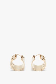 The house’s signature Frame detail elevates these gold-plated brass hoop earrings. Exquisitely crafted in Italy and engraved with the Victoria Beckham logo, they have a latch back closing for a secure and comfortable fit. Designed to elegantly frame the face, they are a wear-anywhere accessory. Customer Note: Due to our hygiene policy, this item is non-refundable. Styled with the Exclusive V- Neck Gathered Waist Floor Length Gown In Ivory  Victoria Beckham Exclusive Frame Hoop Earrings In Gold Modern Gold-tone Pierced Hoop Earrings, Classic Gold Jewelry With Brass Hardware, Small Gold-tone Polished Hoop Earrings, Small Gold-tone Hoop Earrings With Polished Finish, Formal Brass Hoop Earrings, Modern Gold-tone Brass Hoop Earrings, Luxury Pierced Brass Hoop Earrings, Modern Gold-tone Brass Huggie Earrings, Modern Gold Hoop Earrings With Gold-tone Hardware