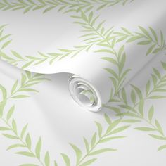 a white and green wallpaper with leafy leaves on the back half of it