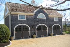 this is an image of a two story house with three car garages on the driveway