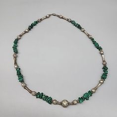 Add a touch of Southwestern elegance to your jewelry collection with this vintage statement necklace. Crafted from liquid sterling silver, this necklace features a beautiful malachite stone in a green color that will complement any outfit. The necklace is 26 inches long and has a barrel closure, making it easy to wear.  this necklace is a must-have for anyone who loves unique and eye-catching jewelry. The necklace is unisex and will suit both men and women. With its Native American brand, this necklace is a true piece of art that will add a touch of tribal style to your wardrobe. Shipped from a smoke-free home.  Please ask any questions in advance.  I combine shipping whenever possible to save you money.  Thank you for your interest! Green Malachite Bohemian Jewelry, Vintage Malachite Jewelry For Gifts, Vintage Malachite Jewelry Gift, Silver Malachite Gemstone Necklace, Traditional Green Malachite Jewelry, Bohemian Malachite Jewelry With Polished Beads, Silver Malachite Necklace With Natural Stones, Native American Necklace, Malachite Stone