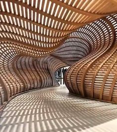 an intricately designed wooden structure with shadows on the floor