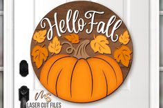 a wooden sign that says hello fall with leaves on it and a pumpkin in the center