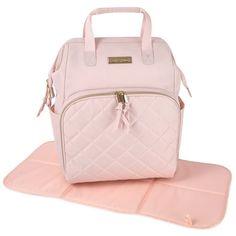 a pink purse sitting on top of a mat