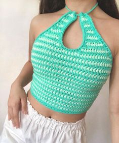 a woman wearing a green crochet halter top