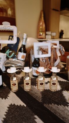 the bottles are sitting on the table next to the bottle openers and other items