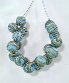 All products are handmade and unique. All beads are made by myself, in my own studio in Turkey-Selçuk-Şirince village. For my work i used Effetre (Moretti) - İtalian glass and the others. Shaped with breath.  Stainless steel wire, transparent silicone cord and nickel free clasp.  About 50 cm  long. If it falls on a hard surface, it may break. Do not wash with water. Wipe gently with a damp, soft cloth. The necklace is in an asymmetrical form.  The form does not deteriorate when you remove the br Artsy Necklace With Unique Variations For Party, Artsy Necklaces For Parties, Party Large Beads Round Beaded Necklaces, Unique Necklaces With Round Beads For Party, Unique Round Bead Necklaces For Party, Turquoise Round Beads Necklace For Party, Handmade Artisan Round Beads, Turquoise Necklace With Large Beads For Party, Turquoise Necklaces With Round Beads For Party