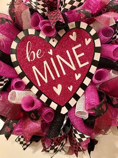 a valentine's day wreath with the words be mine on it