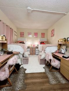 a bedroom with two beds, desks and shelves filled with personal items on top of them