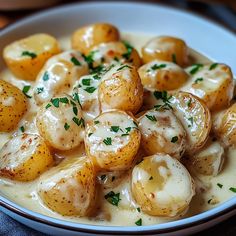 a white bowl filled with potatoes covered in gravy